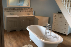 Spacious bathroom with roll top bath