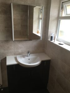 Mirrored cabinet above vanity basin