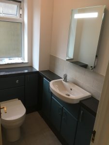 Teal cloakroom with mirror